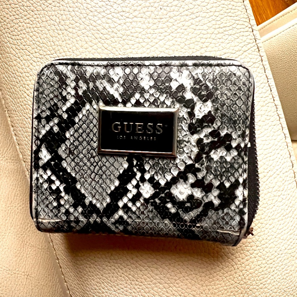 Pairto any bag, this small faux-leather features a python print, zip-aroundclou
